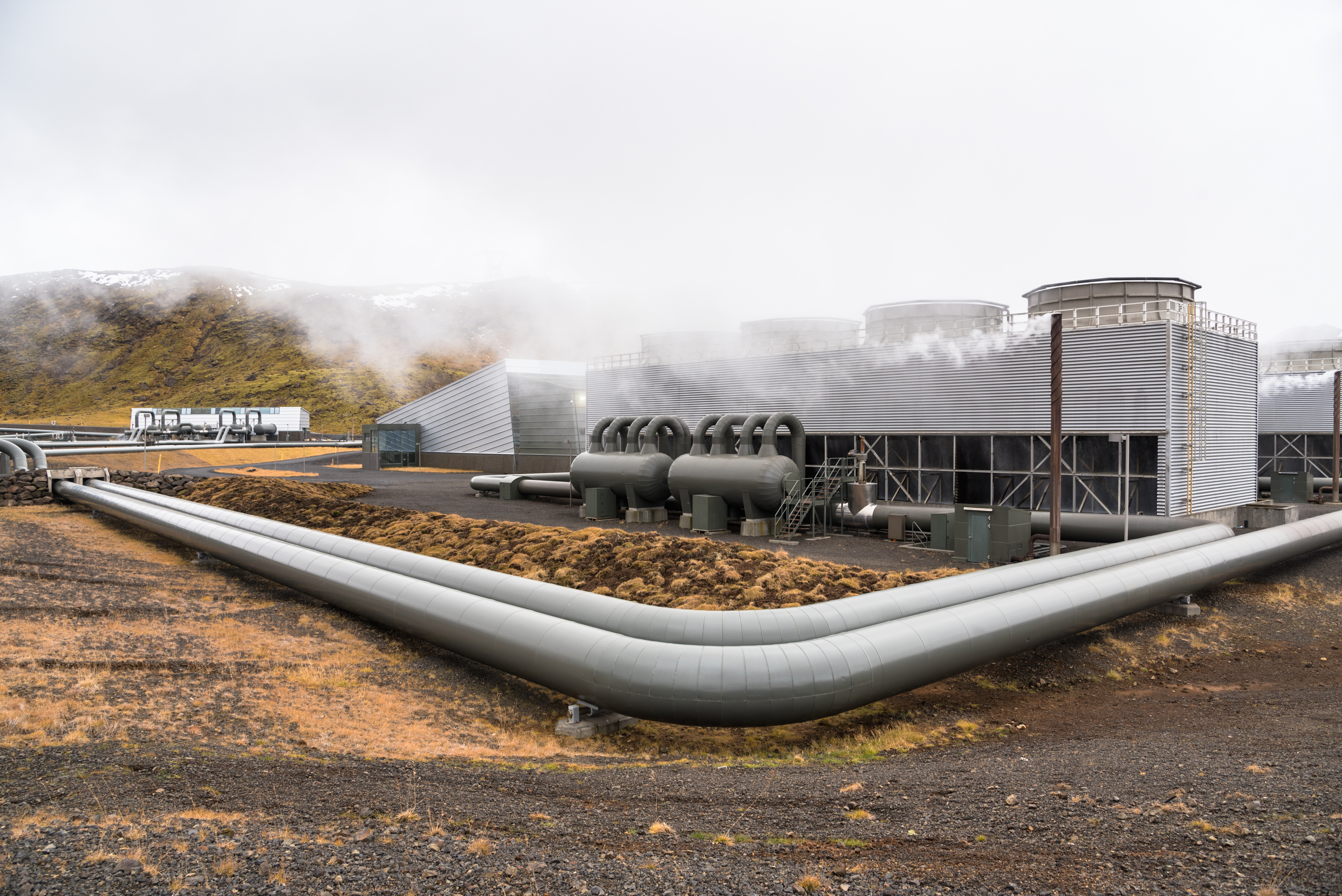 View of a Geothermal Power Plant with Big Steam Pipes on a Cloud